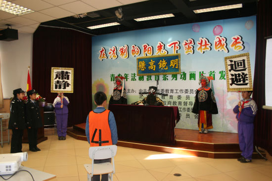 2008年12月4日学生在法制的阳光下茁壮成长-走进法制教育特色校登莱小学的展示活动中，表演情景剧包公审现代案